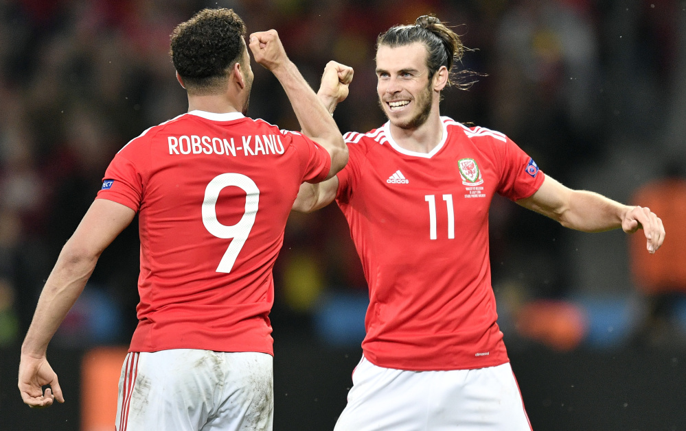 Hal Robson-Kanu, left, and Gareth Bale celebrate Friday after Robson-Kanu scored the second-half goal that gave Wales the lead in what turned into a 3-1 victory against second-ranked Belgium in the European Championship quarterfinals at Lille, France.