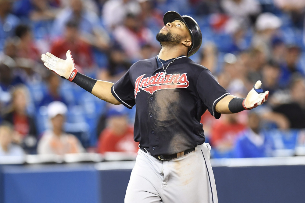 Cleveland's Carlos Santana celebrates his 19th-inning home run at Toronto on Friday. The Indians held on to beat the Blue Jays, 2-1 in 19 innings to run their winning streak to 14 games.
