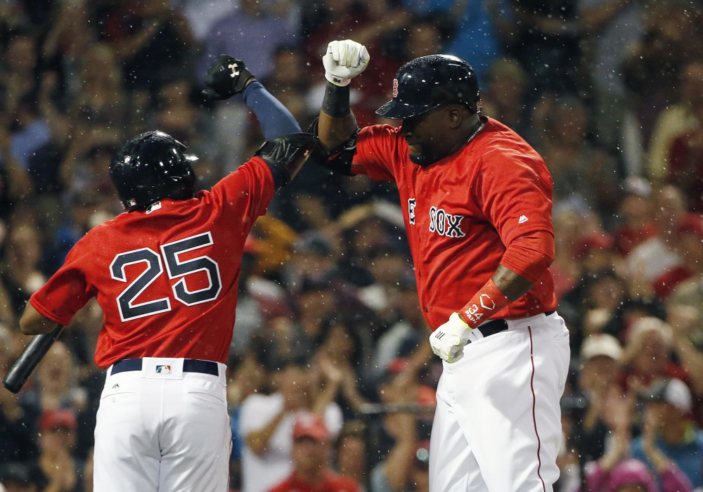 Boston's David Ortiz, right, celebrates his solo home run with Jackie Bradley Jr. in the fifth inning Friday night against the Los Angeles Angels in Boston.