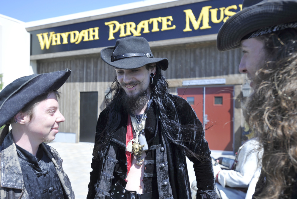 Staff members greet visitors outside the Whydah Pirate Museum during the attraction's grand opening June 25 in West Yarmouth, Mass. The museum is named for a ship called Wydah, which was captained by Black Sam Bellamy.