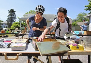 Rachel Wortheimer and Kristen Carbone stop by on their bike ride to shop at a yard sale held by Jim Quatrano in South Portland.
