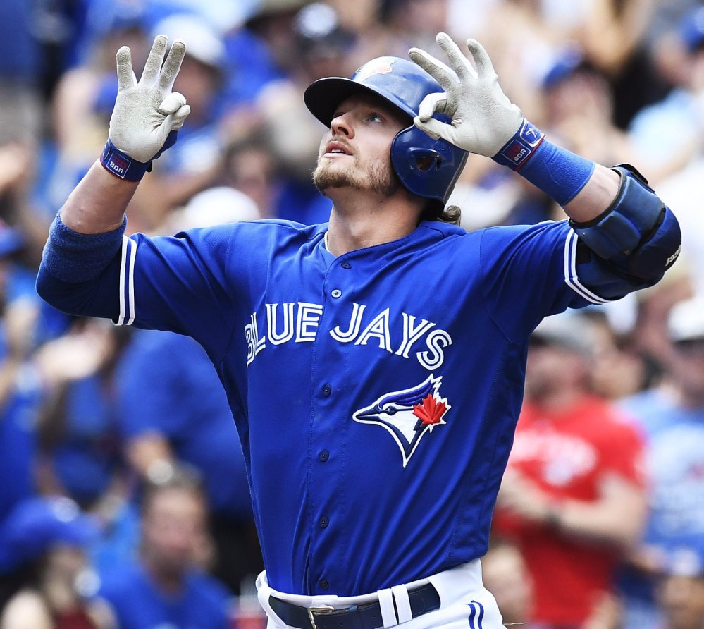 Josh Donaldson of the Blue Jays celebrates after hitting a tying solo home run during the seventh inning of a 9-6 win at home against Cleveland Saturday.
