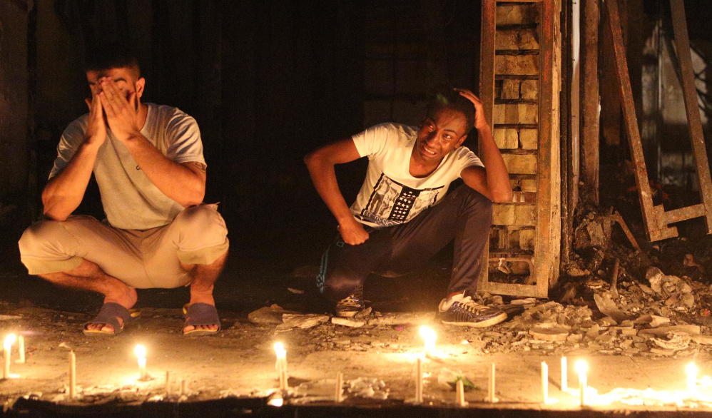 People light candles at the scene of a massive suicide bomb attack in Baghdad on Sunday.