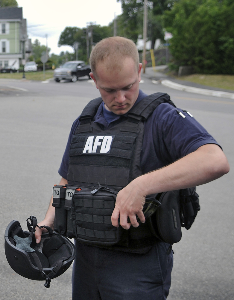 Augusta firefighter Anthony Thibodeau dons a ballistic vest last week at Hartford Station in Augusta. The agency has been using the vests for two years.