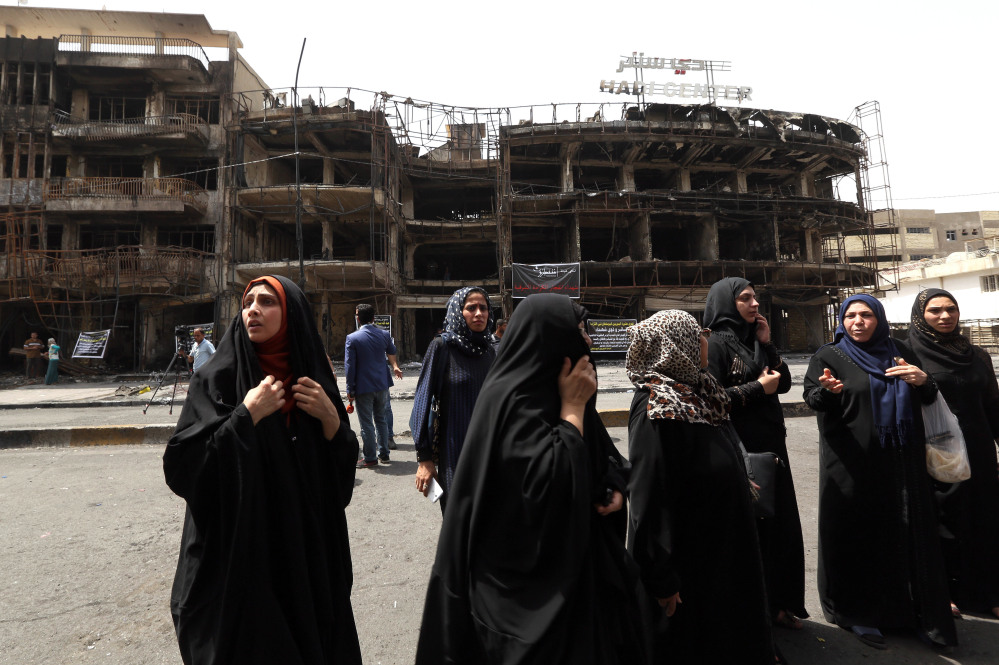 Iraqi women await word on missing family members Monday, the day after a car bomb blast in a commercial area of Baghdad killed at least 200 people.