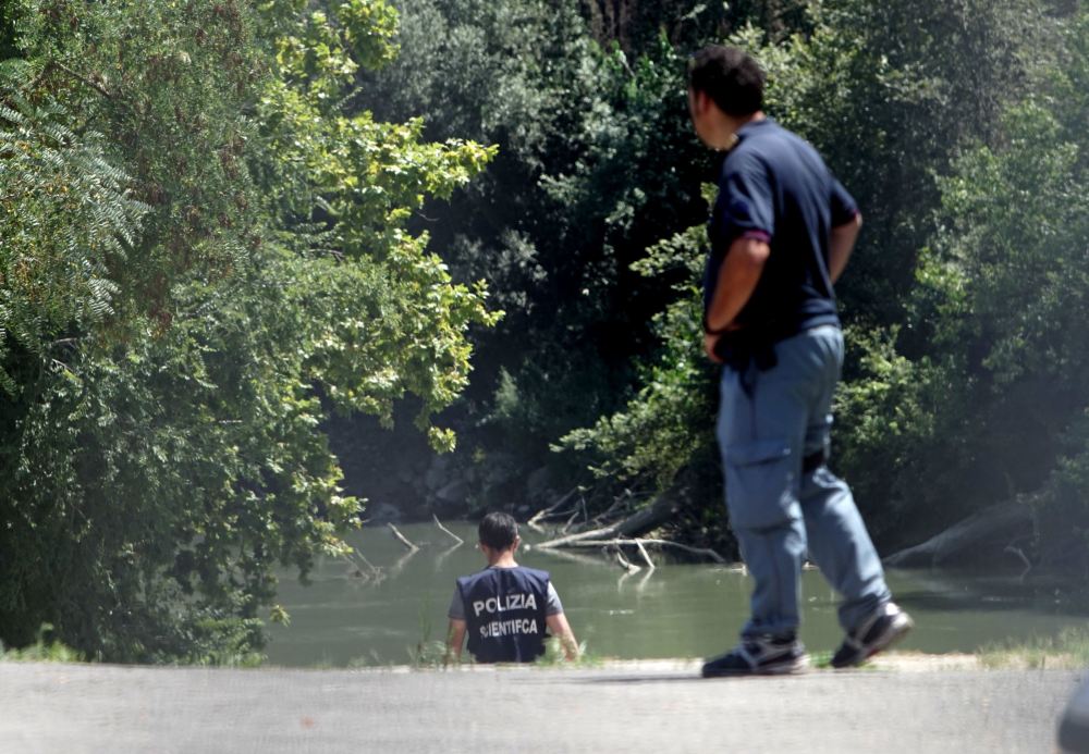 Italian police inspect the banks of the Tiber River in Rome, where the body of a college student from Wisconsin was found Monday. Beau Solomon disappeared soon after he arrived in Rome last week for an exchange program
