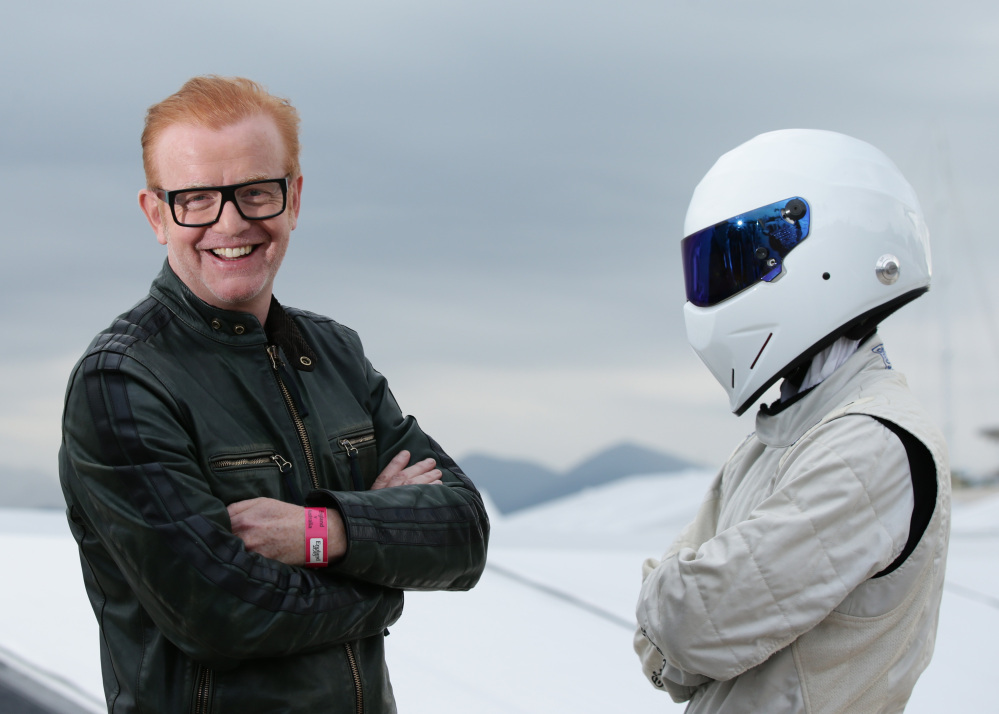 Chris Evans, left, standing with "The Stig" in Cannes, France, announced Monday that he is quitting as host of the BBC's flagship car show, "Top Gear."