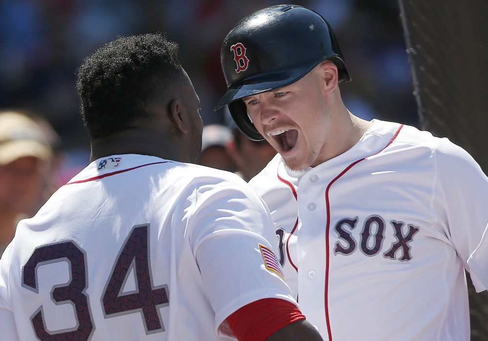 Boston's Brock Holt celebrates his two-run home run in the third inning with David Ortiz at Fenway Park on Monday afternoon.