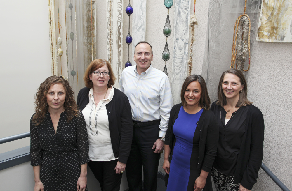 Besides CEO Ted Wirth, center, other top managers at  Diversified Communications include, from left, Amelie Veegaert, operations manager; Mary Larkin, executive vice president; Liz Plizga, vice president-group event director; and Christine Pederson, marketing director.