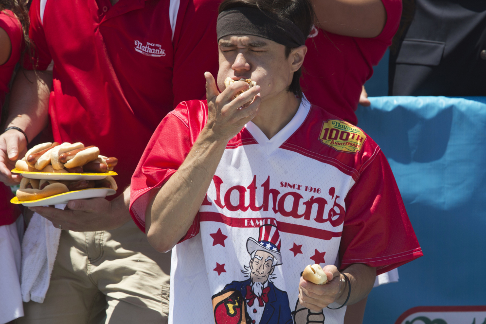 Associated Press/Mary Altaffer
Matt Stonie competes in Nathan's Famous Fourth of July International Hot Dog Eating Contest men's competition Monday in New York. Stonie came in second, eating 53 hot dogs and buns in 10 minutes.