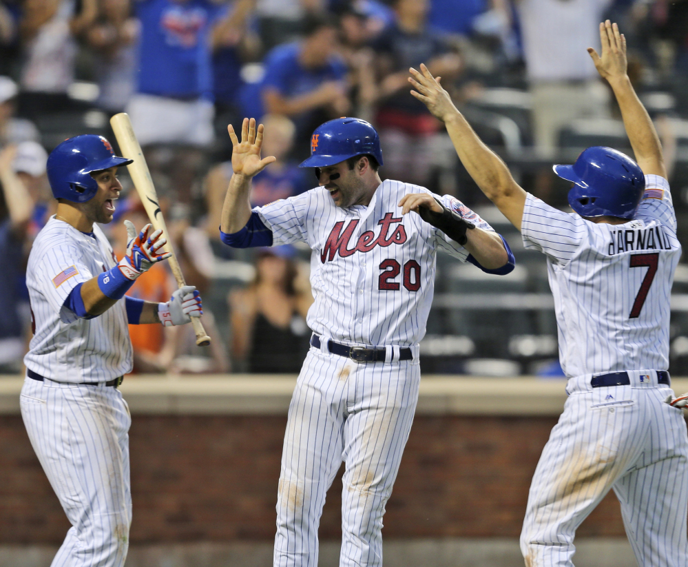 James Loney, from left, Neil Walker and Travis d'Arnaud celebrate at home after a two-run double by Yoenis Cespedes in the Mets' win Monday at New York.