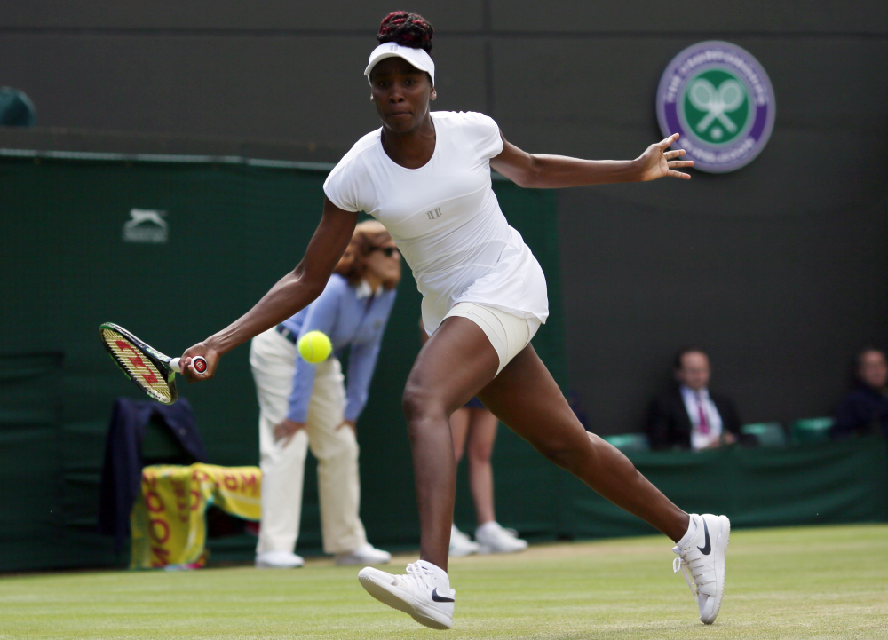 Venus Williams returns to Yaroslava Shvedova of Kazahkstan during their women's singles match at Wimbledon. Williams reached the semifinal round for the first time in seven years by beating Shvedova.