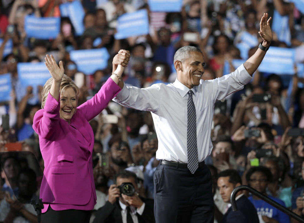 President Obama and Hillary Clinton wave to the crowd after speaking Tuesday at a campaign rally for Clinton in Charlotte, N.C., where the president said, "I'm here today because I believe in Hillary Clinton."