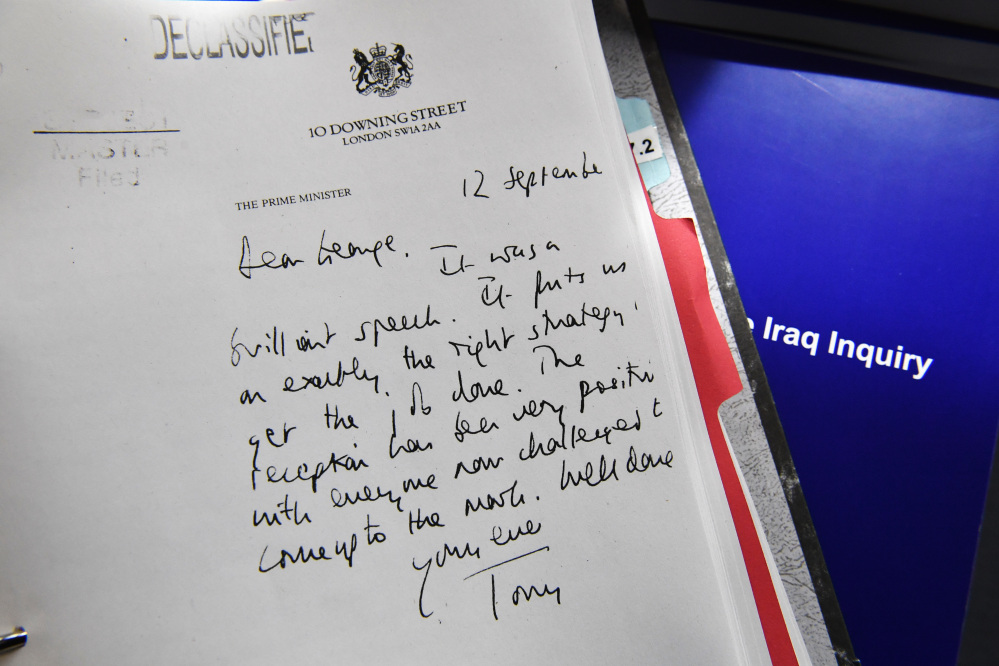 A detail of a declassified handwritten letter sent by British Prime Minister Tony Blair to U.S. President George W. Bush is shown as part of the Iraq Inquiry Report presented by Sir John Chilcot at the Queen Elizabeth II Centre  in London on Wednesday. 