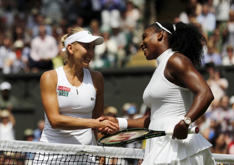 Serena Williams shakes hands with Elena Vesnina of Russia after beating her in their women's singles match at Wimbledon