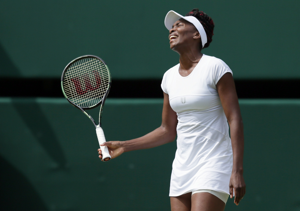 Venus Williams of the U.S reacts during her women's singles match against Angelique Kerber of Germany on day eleven of the Wimbledon Tennis Championships in London.