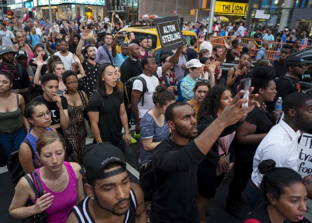 Protesters march in New York's Times Square on Thursday in response to the police shooting deaths of Philando Castile in St. Paul, Minn., and Alton Sterling in Baton Rouge, La.
