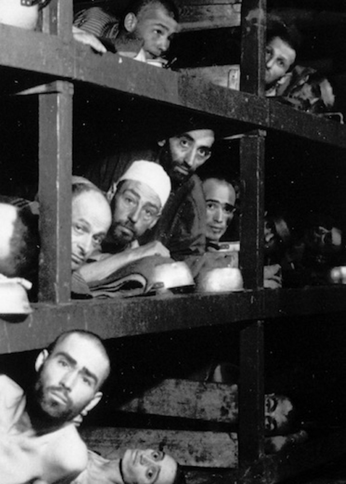 This 1945 file photo provided by the Army shows inmates of Buchenwald inside their barracks, a few days after U.S troops liberated the concentration camp near Weimar. The young man fourth from left in the middle row bunk is Elie Wiesel, who would later become an author and Nobel Peace Prize laureate.