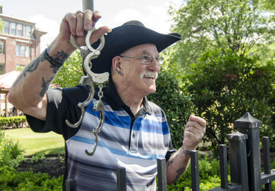 Retired escape artist Roger Lavoie holds handcuffs in Fitchburg, Mass. His feats of escape included freeing himself from an oil drum filled with angry tarantulas.