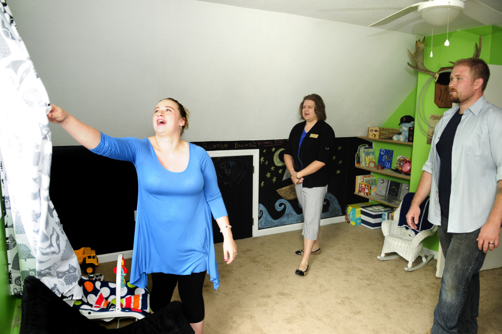 Abby Utecht, left, and Steven Utecht show Sarah Graettinger, a staff member from U.S. Sen. Angus King's office, the nursery of their new home in Richmond on Friday.
