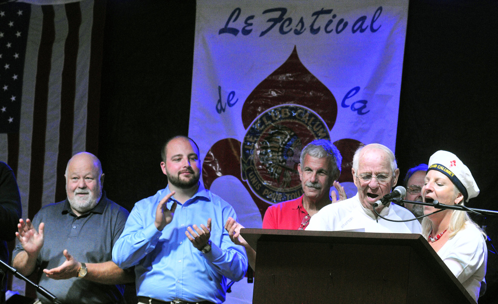 Larry Guimond and Rachel Boucher Ellis lead Le Club Calumet's anthem Friday during the opening night of Le Festival de La Bastille in Augusta. Earlier, Guimond had sung the Canadian anthem, Boucher Ellis the French anthem and Tina Charest the American.