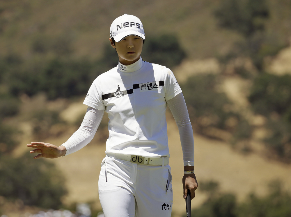 Sung Hyun Park waves after making a birdie putt on the 16th hole during the second round of the U.S. Women's Open on Friday in San Martin, California. Park shot a 6-under 66 to grab a two-stroke lead.