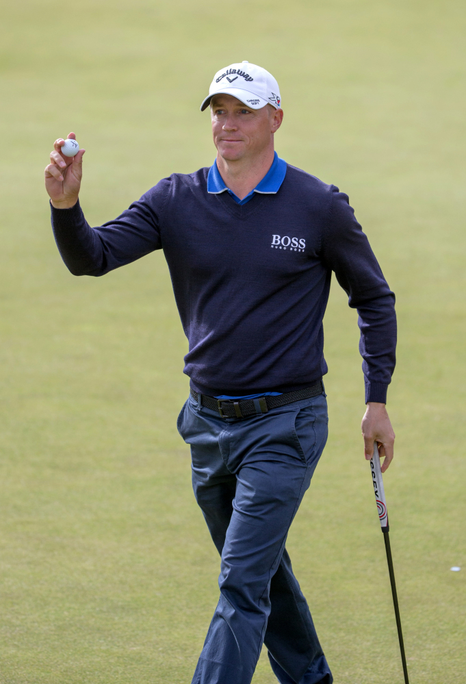 Sweden's Alex Noren acknowledges the fans after his birdie on the eighth hole gave him the lead at the Scottish Open. Noren was at 8-under 136 after shooting a 66.