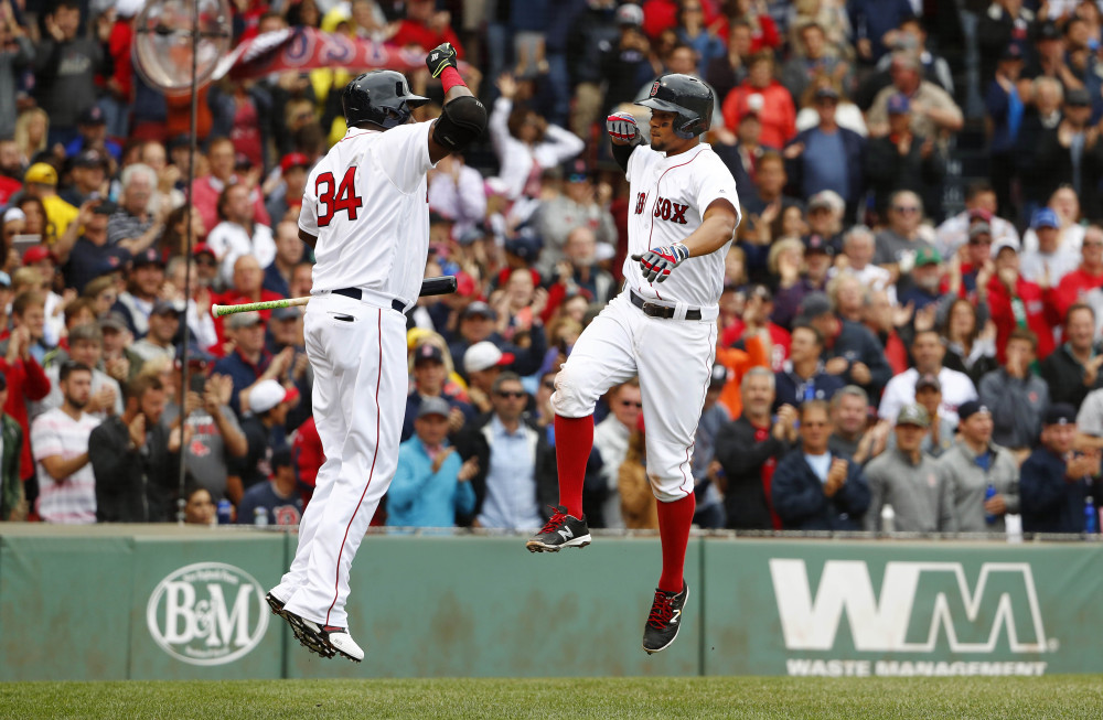 Xander Bogaerts, right, celebrates his two-run home run with teammate David Ortiz during the fourth inning =against the Tampa Bay Rays on Saturday. The Red Sox won, 4-1.
