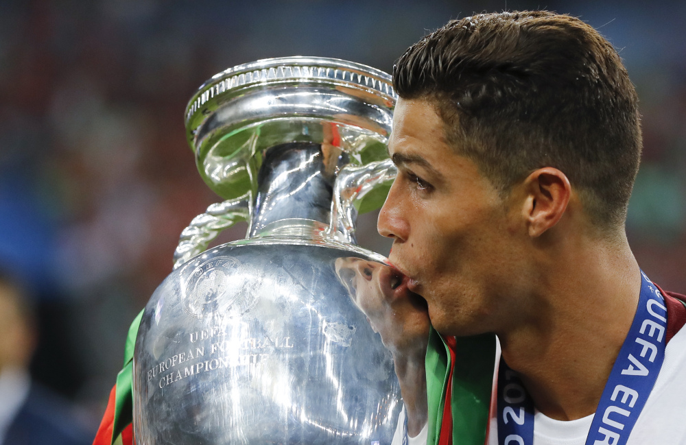 Cristiano Ronaldo kisses the championship trophy Sunday after Portugal beat France 1-0 in the final of the European Championships in Saint-Denis, France.