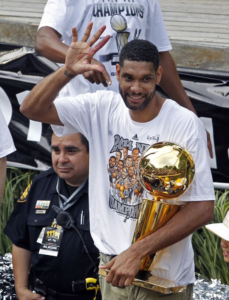 At celebration in June 2014, after San Antonio beat Miami for the championship, Tim Duncan shows fans five fingers representing the five NBA titles his Spurs won. Duncan announced his retirement on Monday after 19 seasons, five championships, two MVP awards and 15 All-Star appearances.