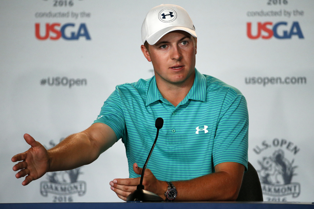 FILE - In this June 13, 2016, file photo, defending U.S. Open champion Jordan Spieth talks with reporters after a practice round for the 2016 US Open golf championship at Oakmont Country Club in Oakmont, Pa. Spieth is out of the Olympics. International Golf Federation president Peter Dawson announced the decision at the British Open. Spieth had been strongly debating whether to go over the last three days before reaching his decision on Monday, July 11, 2016. He will be replaced by Matt Kuchar. (AP Photo/Gene J. Puskar)
