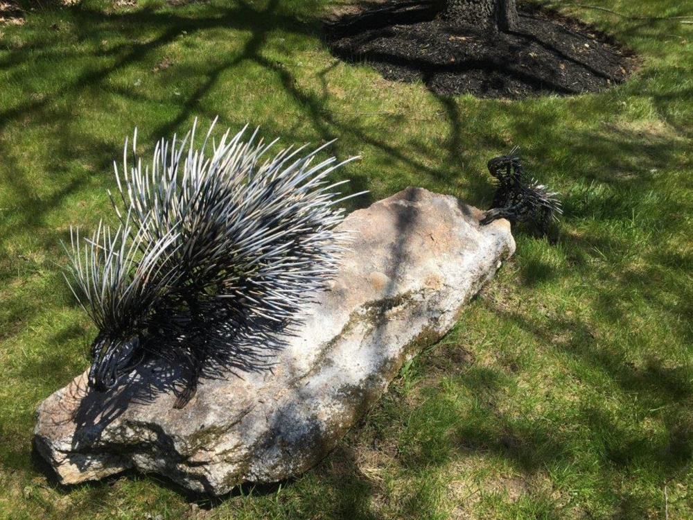 The sculpture by Wendy Klemperer that is part of a grouping at the Portland International Jetport features a baby porcupine following its mama across the rock.