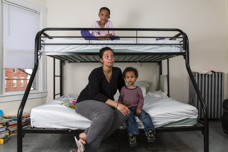 Carmen Ware and her children spend time in the apartment they share with another family at the Chestnut Street shelter. Several local churches are trying to build a coalition of host families willing to provide temporary housing to new arrivals.