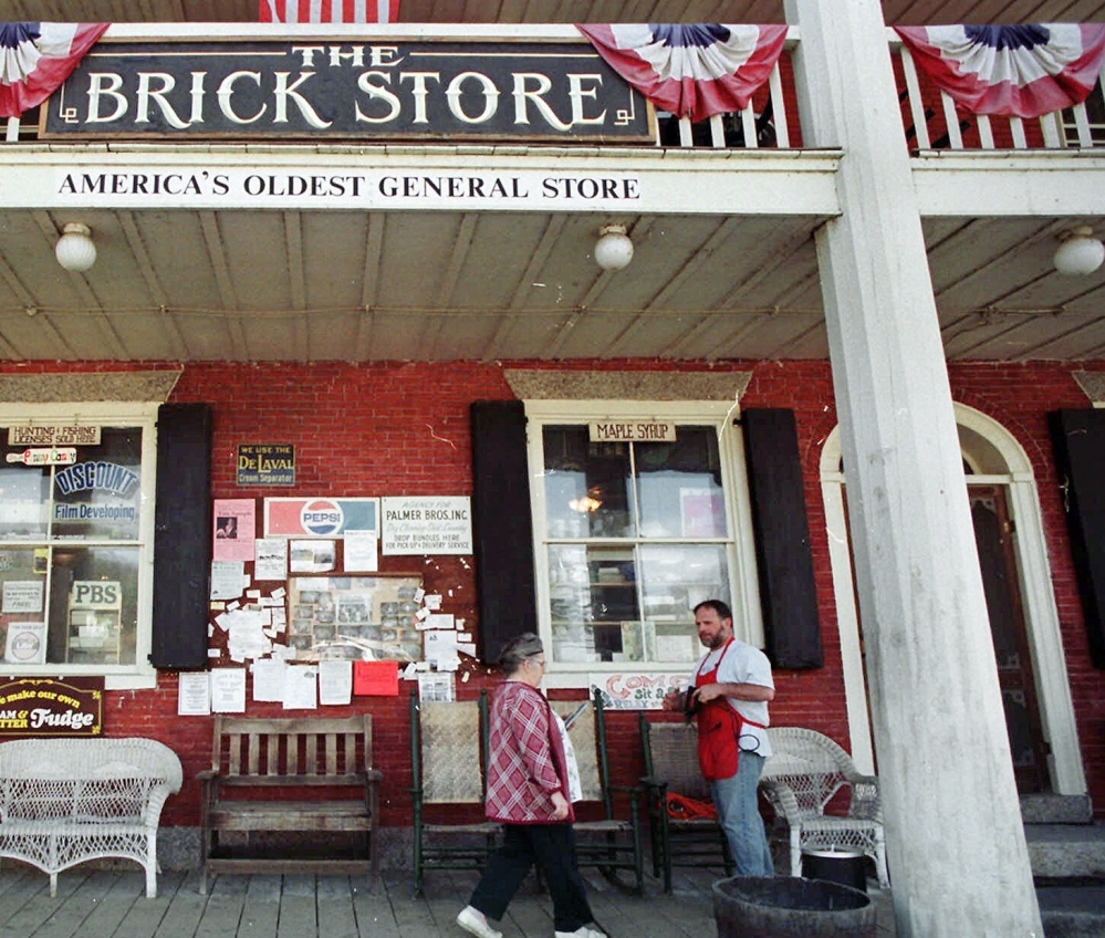 Mike Lusby greets customers on the porch of the Brick Store in 1999 in Bath, N.H. A local investor bought the property.