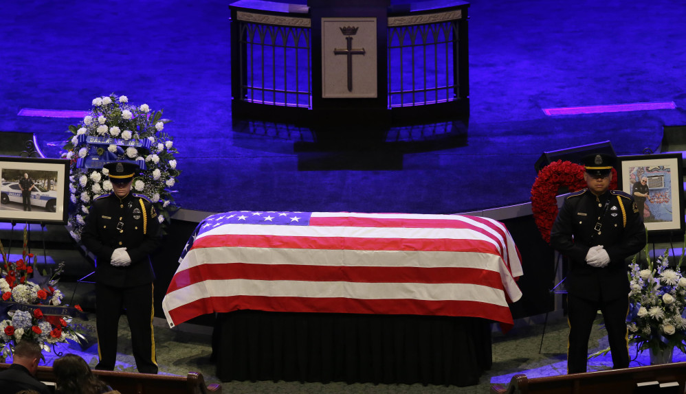 An honor guard stands watch over the casket of Dallas Police Sr. Cpl. Lorne Ahrens during his funeral service at Prestonwood Baptist Church in Plano, Texas, on Wednesday.