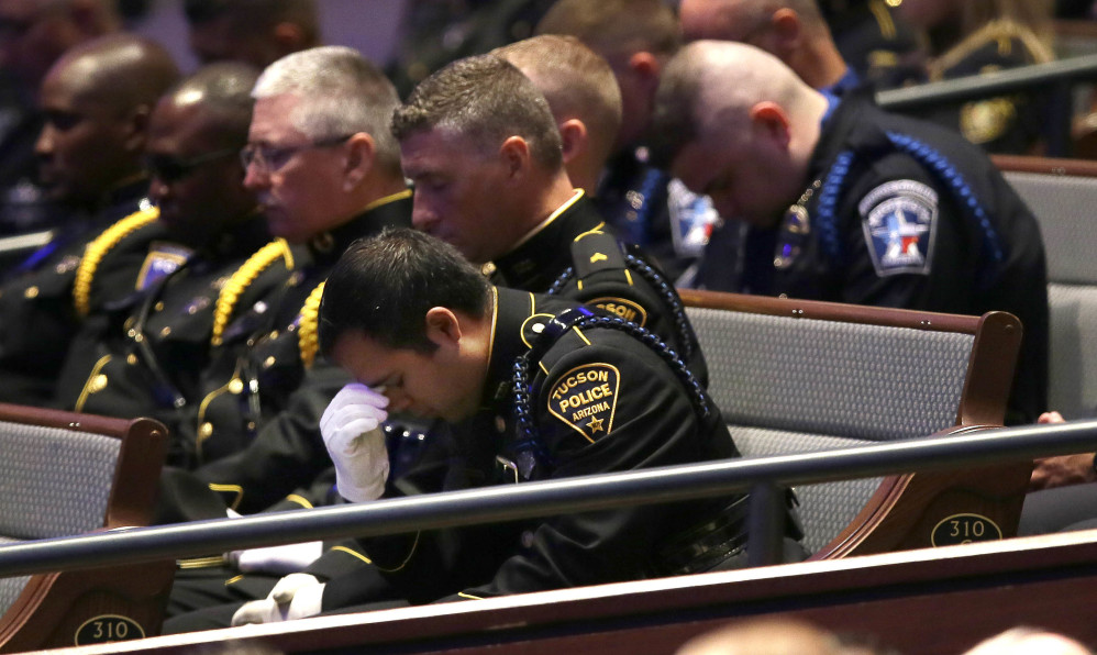 Law enforcement officers bow their heads in prayer during funeral services for Dallas Police Sr. Cpl. Lorne Ahrens at Prestonwood Baptist Church in Plano, Texas, on Wednesday.