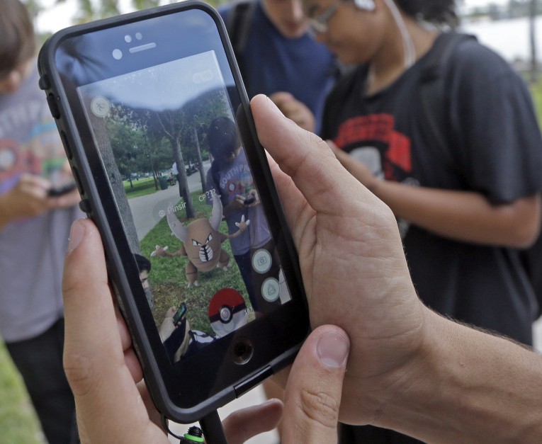 Pinsir, a Pokemon, is found by a group of "Pokemon Go" players at Bayfront Park in downtown Miami on Tuesday.