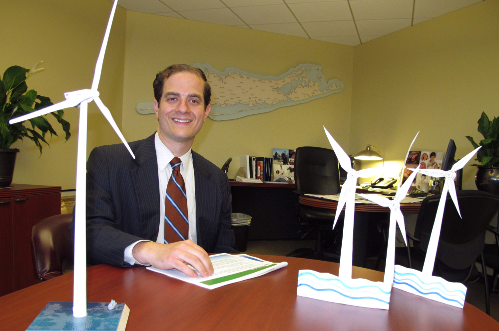 Long Island Power Authority Chief Executive Officer Thomas Falcone sits in front of some models of offshore wind turbines at the utility's offices in Uniondale, N.Y. The utility is moving forward with plans to construct the nation's largest wind energy farm off eastern Long Island.