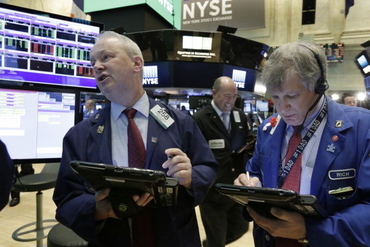 Trader James Riley, left, and Richard Newman work on the floor of the New York Stock Exchange on Thursday.