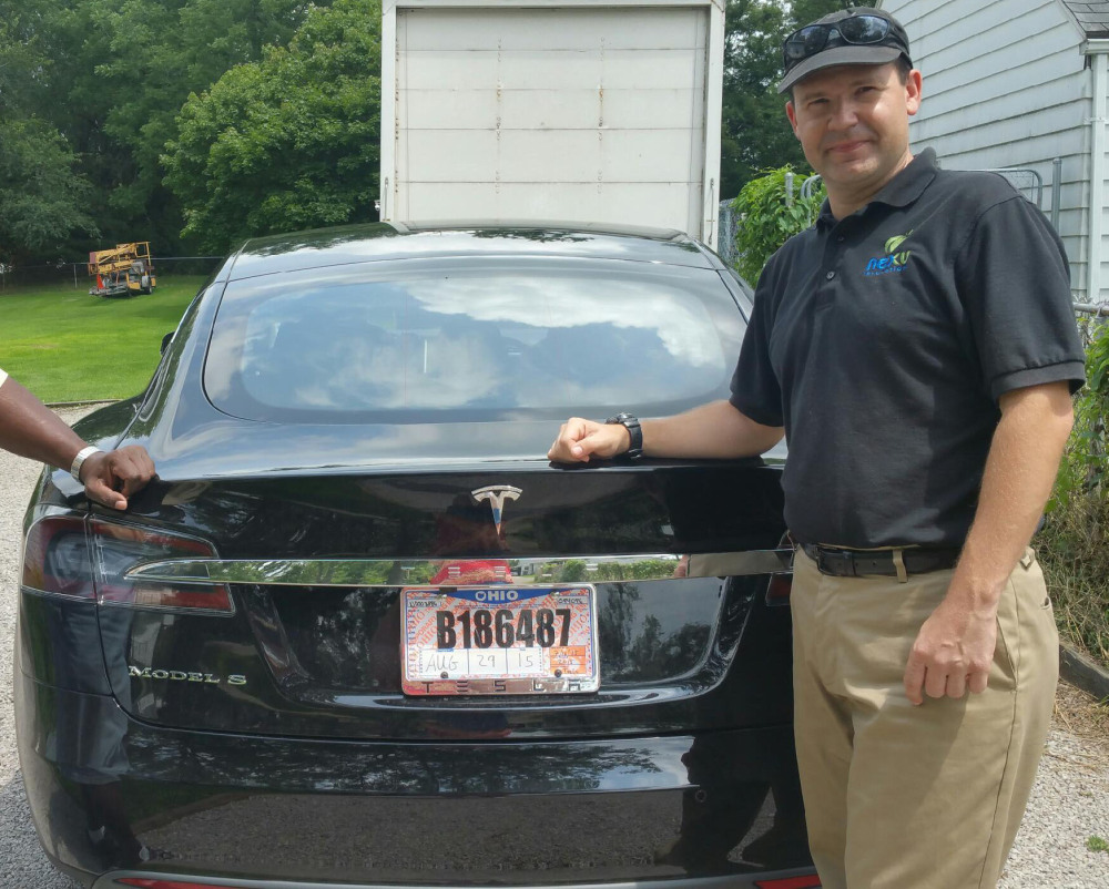 Joshua Brown stands by his new Tesla electric car near his home in Canton, Ohio. Brown died in an accident in Florida in the first fatality from a car using self-driving technology.