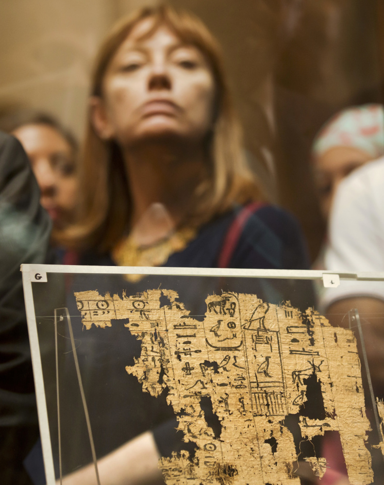 A visitor looks at one of the oldest papyruses among the collection of King Khufu.