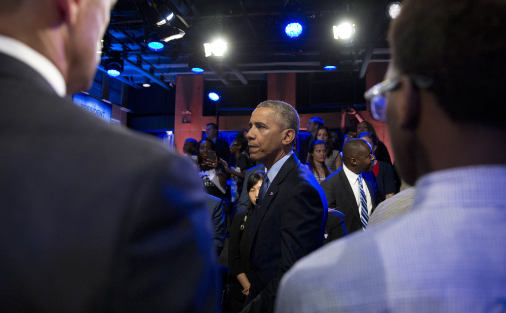 President Obama greets audience members after participating in a town hall discussion taped with ABC news anchor David Muir in Washington Thursday.
