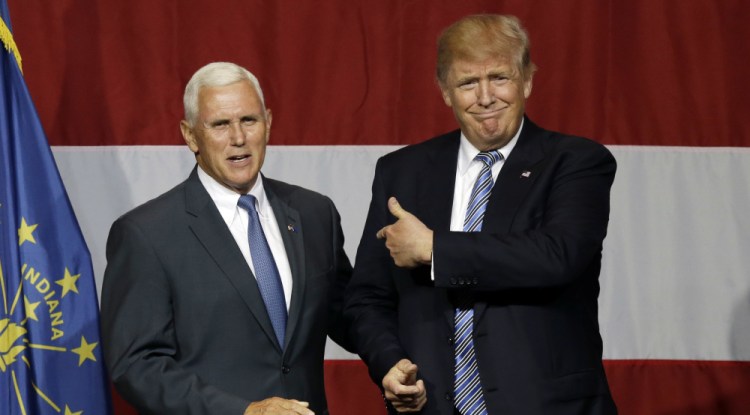 Indiana Gov. Mike Pence joins Republican presidential candidate Donald Trump at a rally in Westfield, Ind., on July 12. Pence's decision to join Trump on the ticket is at odds with his previous positions.
