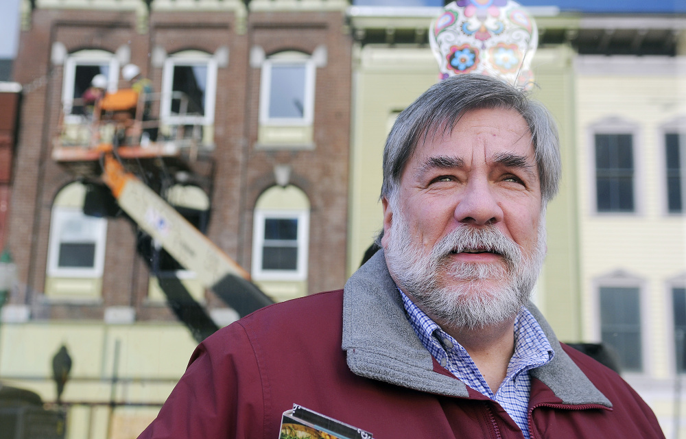 Gardiner Mayor Thom Harnett watches the demolition of 235 Water St. last November after a fire there in July.