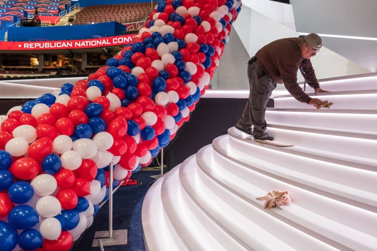 A member of a construction crew polishes the front of the stage for the opening of the Republican National Convention in Cleveland. With protesters planning to make noise and the Republican Party still divided over the nomination of Donald Trump, some Maine delegates say the convention could be contentious.