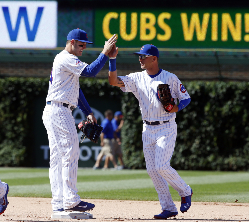 Anthony Rizzo, left, of the Chicago Cubs greets Albert Almora Jr. after the Cubs beat the Texas Rangers 3-1 in an interleague game Saturday in Chicago.
