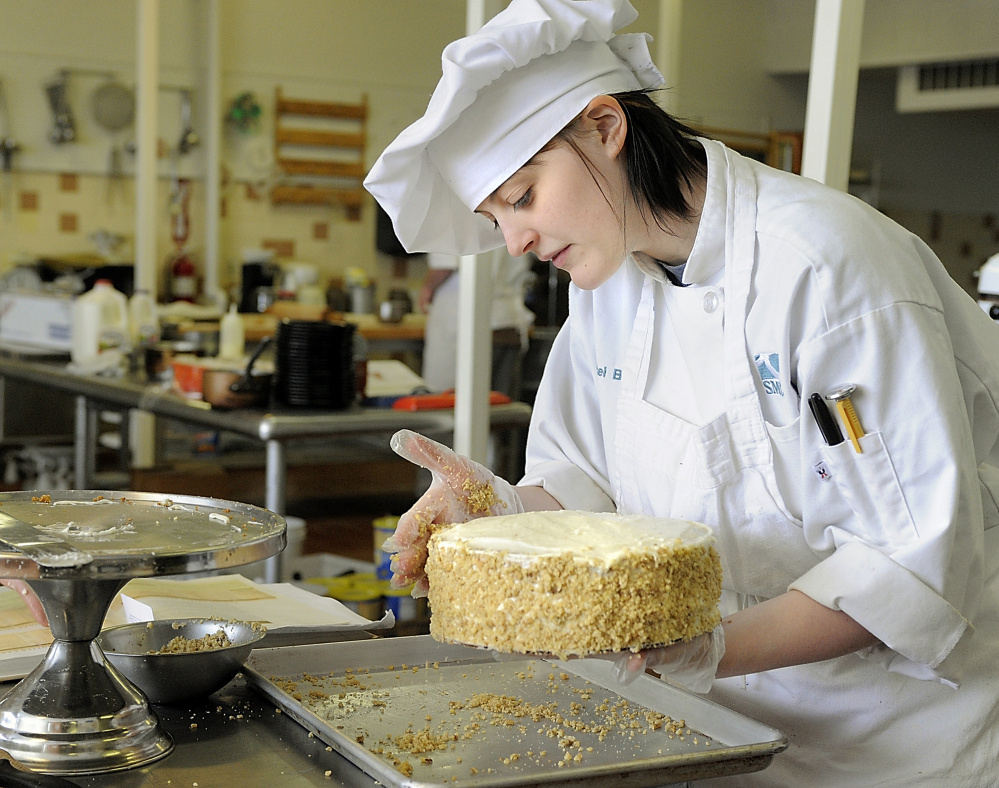 Culinary arts student Chauncel Berry adds nuts to a carrot cake she made for a four-course meal in 2010 that was open to the public.