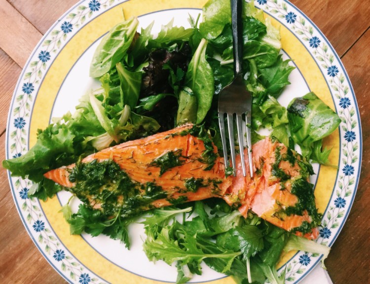 Fillet of salmon in an herb marinade and served over a green salad is the kind of light meal that appeals during summer.