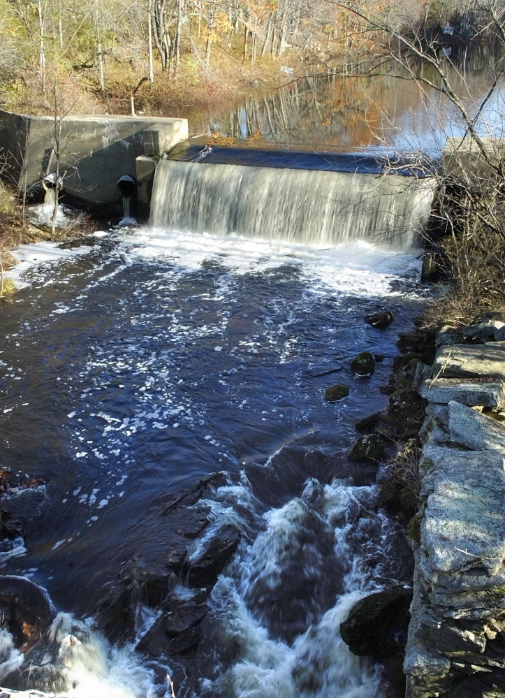 The Sheepscot River flows over the Coopers Mills Dam in Whitefield in 2007. Local officials learned Tuesday that federal money will be available to help pay for the dam's removal.