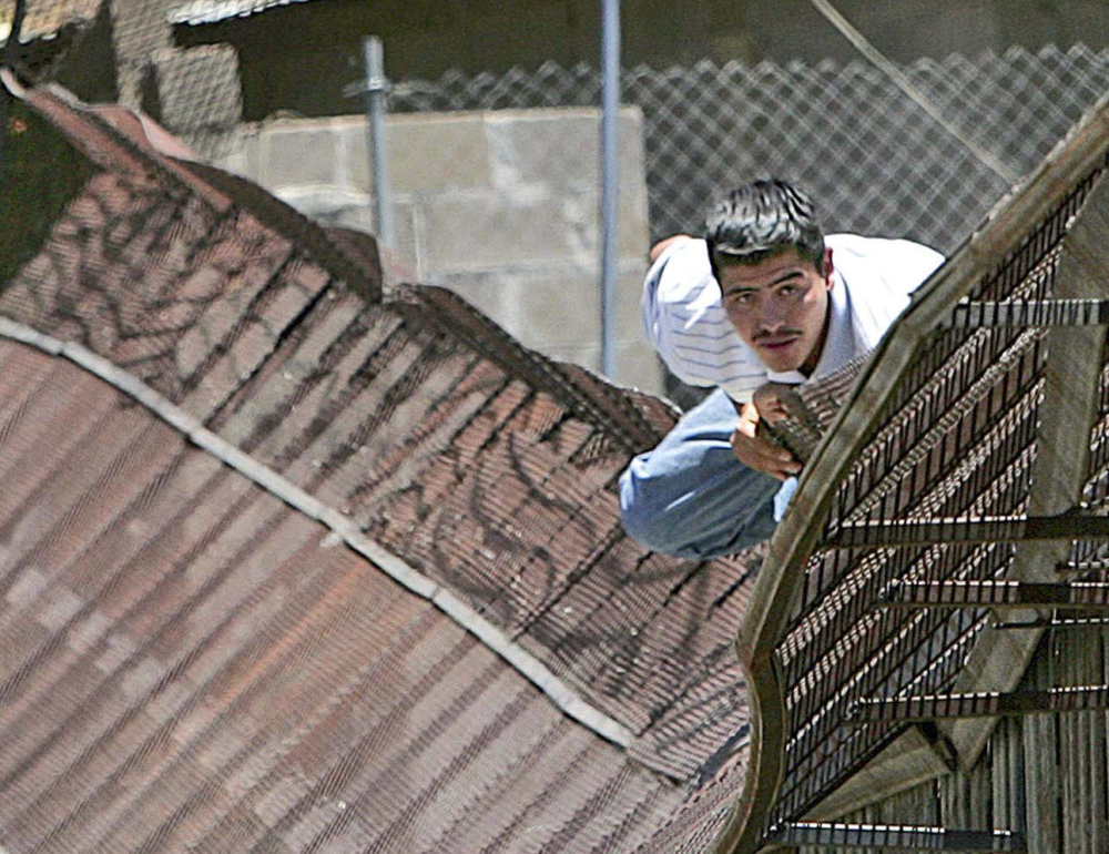 A man climbs over the border into Nogales, Ariz., from Nogales, Mexico, in 2006. People caught crossing the border illegally may face multi-year waits for their courts to hear their cases.